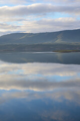 Fototapeta premium Cloud reflections over mountain lake