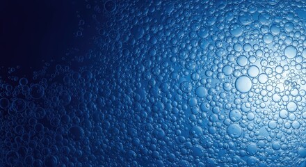 Obraz premium Closeup of blue bubbles on a wet surface with light reflection water
