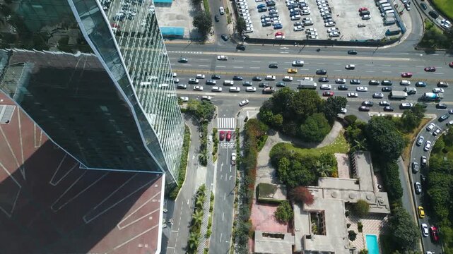 Aerial top-down view of the Westin Hotel main entrance and valet parking area in Lima, showing the urban flow next to Javier Prado avenue in 4K.