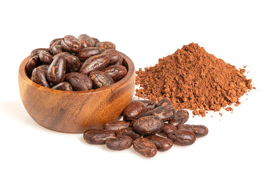 Organic roasted cacao beans in bowl and pile of dark cocoa powder.  Natural ingredients for chocolate making isolated on white background.