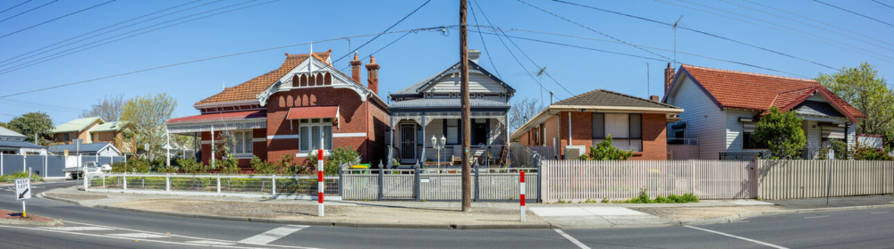 Panoramic view of adjoining residential homes of contrasting architectural eras on a suburban street corner in Melbourne, Australia.&nbsp;Characteristic of residential heritage across different periods