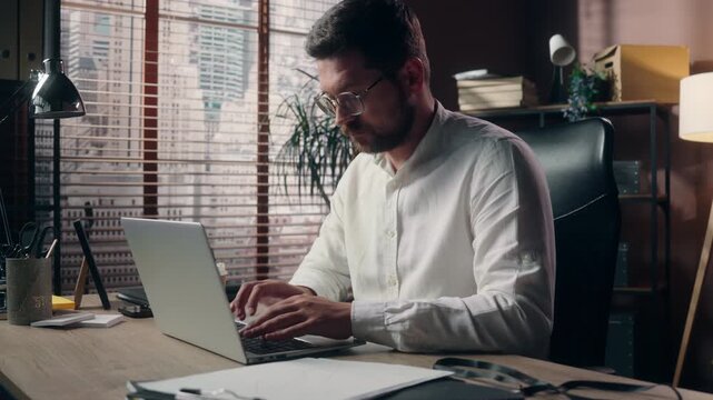 Caucasian middle aged business man typing on laptop indoor modern office businessman searching data online focused male CEO manager working on computer browsing internet employee at company workplace