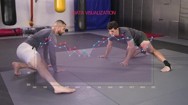 Partners starting martial arts warm-up on mat sliding leg and shifting weight while data overlaying