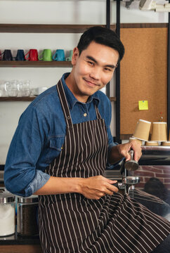 Vertical Horizon Portrait barista Asian man coffee shop smiling look at camera. confident Small business owner Entrepreneur manager men standing coffee counter bar. Vertical Barista small business