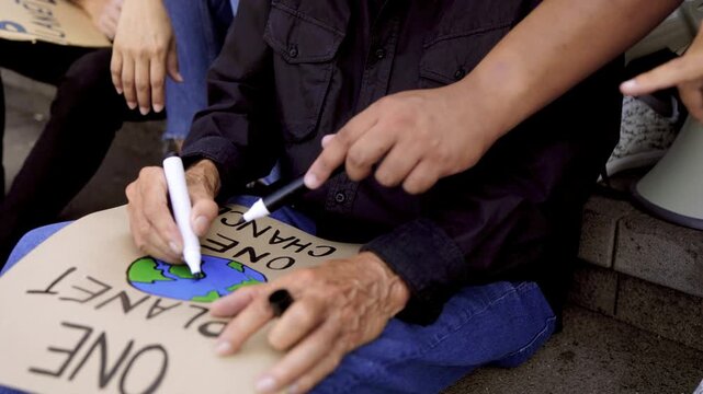 Climate change activist. People prepare banner for environmental protest