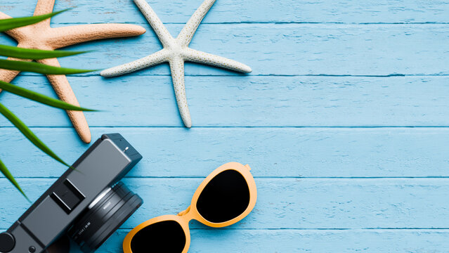 Camera and sunglasses with starfish on blue wood. Copy space. 3d renderring
