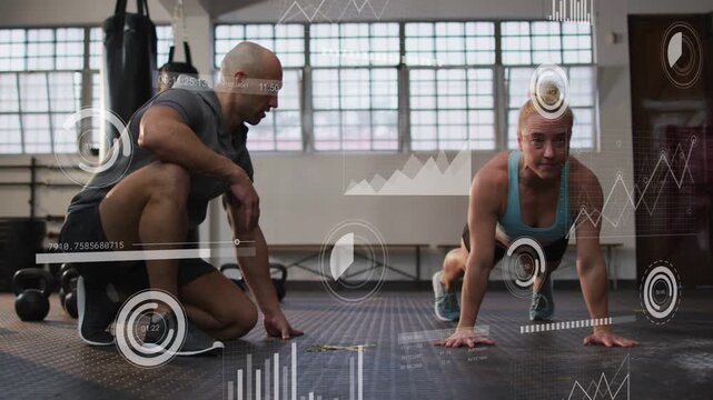 Trainer kneeling cueing trainee performing push-ups in fitness gym, HUD progress bars tracking form