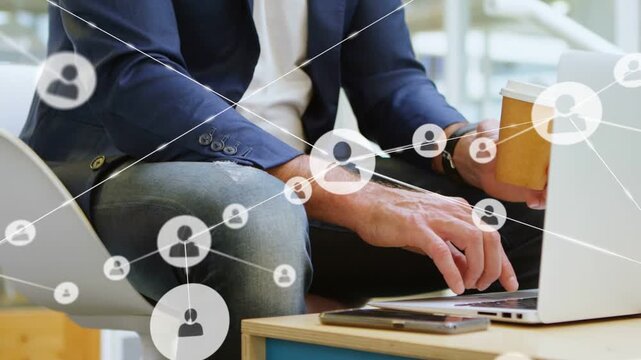 Man tapping trackpad in office, generating animated user nodes linking over laptop for networking