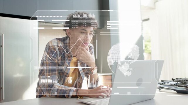 Male student sitting at kitchen counter, HUD updating charts and globe while analyzing tech data
