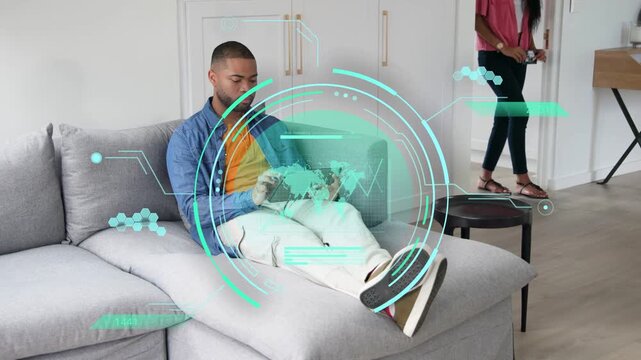 Man tapping tablet activating teal tech HUD over lap analyzing map while woman pausing near table