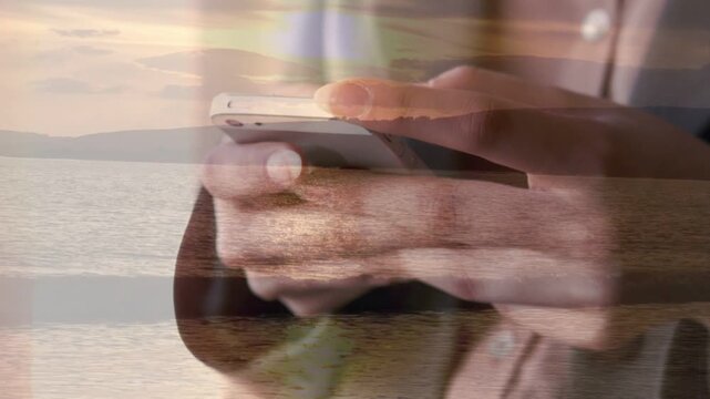 Thumb initiating tapping, hands cradling white phone, scrolling to check messages overlaid by sea