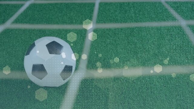 Net vibration causing soccer ball rolling and rotating on turf, hex bokeh drifting, ball settling