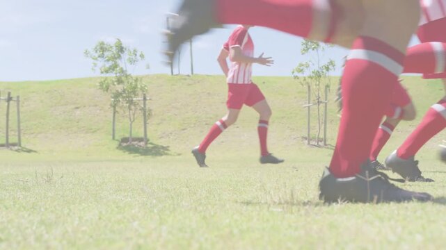 Soccer players entering and sprinting across field as neon streaks crossing cleats for training
