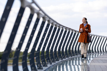 Woman walking modern bridge commuter lifestyle © Jelena