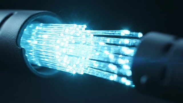 Fiber optic cables glowing blue for high speed data transmission, internet connectivity, and network technology
