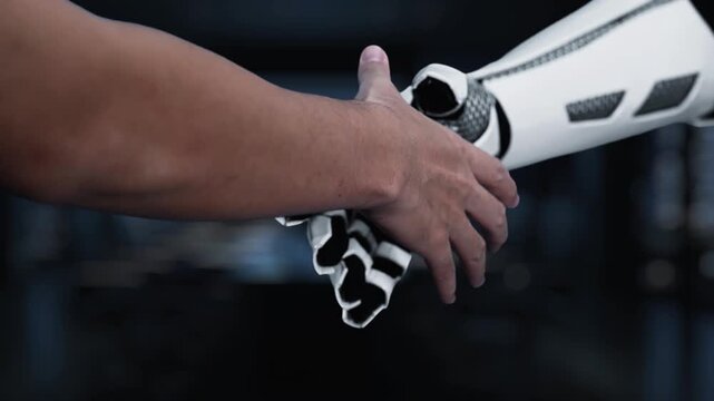 A human finger points towards a digital display showcasing data patterns alongside a robotic arm, emphasizing the synergy between technology and human oversight in a modern workspace. Synapse