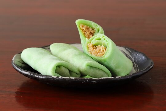 Close up shot of some homemade Indonesian coconut pancake "Dadar Gulung" on plate in natural light.