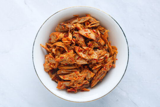 Top view of a bowl of shredded skipjack tuna, a spicy shredded fish dish from Manado, North Sulawesi.