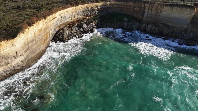 Great Ocean Road, Peterborough, Victoria, Australia: 4K aerial drone footage of London Arch (Bridge), Port Campbell National Park, limestone cliffs, ocean waves, rock formations, rugged coastline