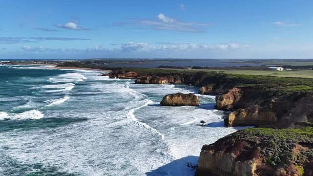 The Grotto Track, Great Ocean Road, Peterborough, Victoria, Australia: 4K aerial drone footage of limestone cliffs, ocean waves, blue sea, rock formations and rugged coastline. 