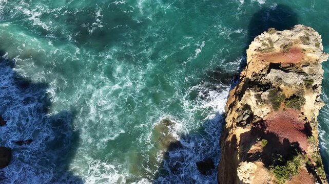 The Grotto Track, Great Ocean Road, Peterborough, Victoria, Australia: 4K aerial drone footage of limestone cliffs, ocean waves, blue sea, rock formations and rugged coastline. 
