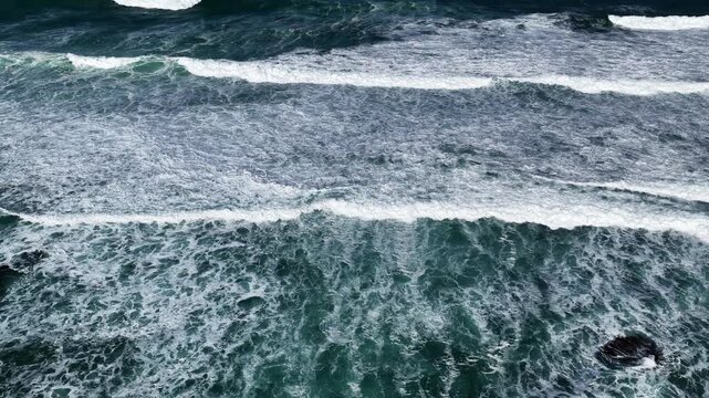 The Grotto Track, Great Ocean Road, Peterborough, Victoria, Australia: 4K aerial drone footage of limestone cliffs, ocean waves, blue sea, rock formations and rugged coastline. 