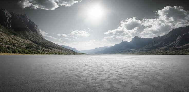 Vast serene sunlit dry lakebed stretching toward jagged mountain valley with distant ridges and scattered clouds, evoking tranquility and wide open solitude