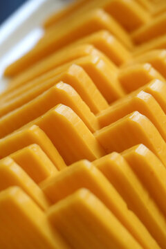 Blocks of cheese arranged in a neat pattern on a tray