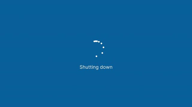 Shutting Down notification on Computer Screen on classic blue background with dotted round Loading Circle Animation. Shut Down desktop PC operating system processing. 4K Infinite Loop.