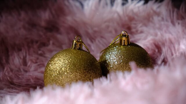 Festive details, Golden baubles on a fluffy throw, holiday magic!  The light dances on their shiny surfaces is Christmas joy, vibes