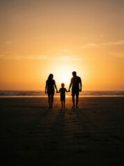 Fototapeta premium A family of three standing together, holding hands, silhouetted against a warm, glowing sun.