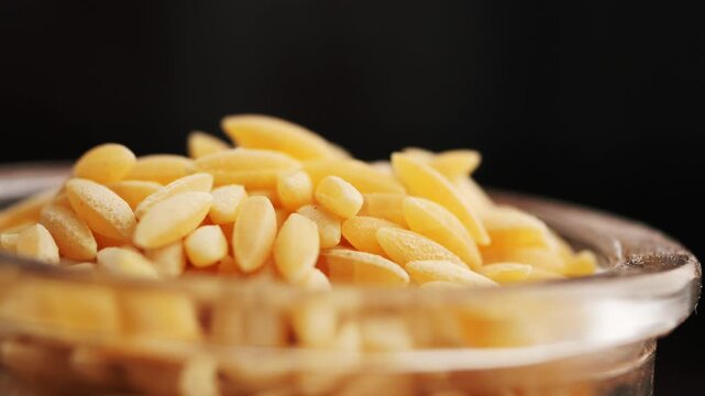 Close-up of Dry Orzo Pasta in a Glass Bowl