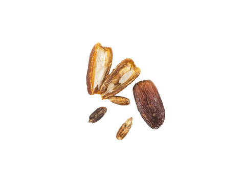 Isolated dates and date pit with split open fruit showing flesh and seed on Transparent background, top view, studio cutout for food and ingredient concepts.