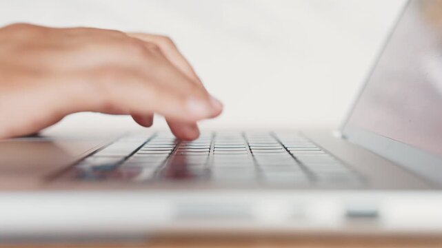 Detailed Side View of Human Fingers Pressing Buttons on Silver Laptop. Person Working or Studying Online Using Technology Notebook. Cinematic 4K Slow Motion Footage of Digital Communication Process