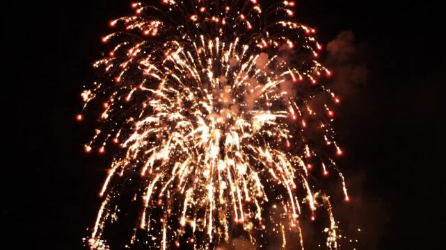 Bright fireworks exploding isolated against a pure black background