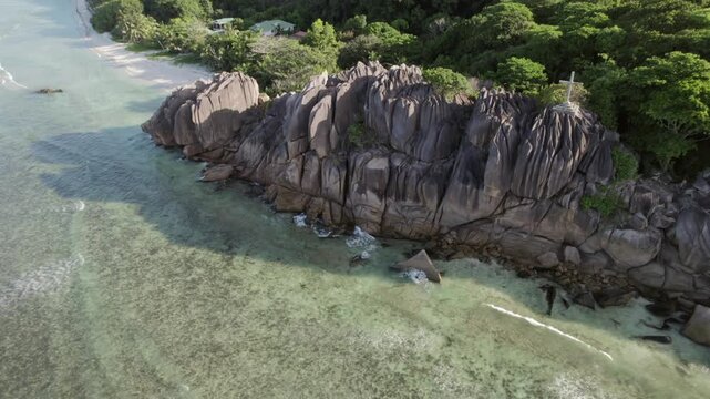 Stunning drone reveal of massive granite boulders, turquoise water, and lush tropical forest at Anse Grosse Roche, La Digue, Seychelles 012 30fps