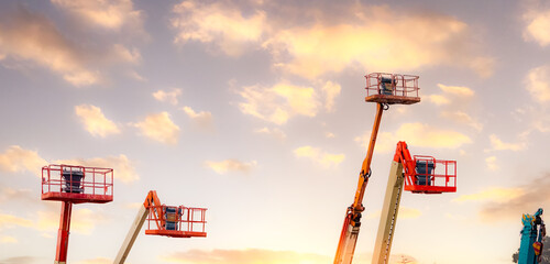 Articulated boom lift. Aerial platform lift. Telescopic boom lift against the sky. Mobile construction crane for rent and sale. Maintenance and repair hydraulic boom lift service. Crane dealership. © Fahroni