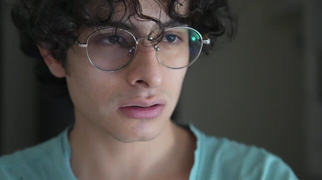 Close-up of Young Man with Glasses Looking Tired and Overwhelmed, Emotional Burnout Concept