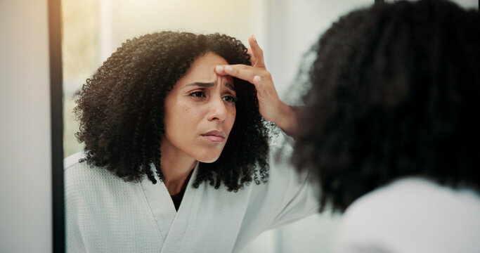 Woman, concern and check face in mirror with skincare, inspection or fear for acne breakout in bathroom. Female person, skin evaluation and dermatology in house with reflection, worry or pimple issue