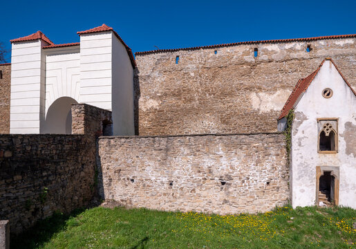 Vrbov Gate and preserved medieval city walls in Levoča, Slovakia. Historic fortifications with stone masonry and defensive architecture under clear blue sky.