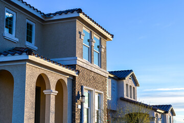 Fototapeta premium Newly completed two-story homes in a residential subdivision, representing housing development, suburban living, and real estate growth