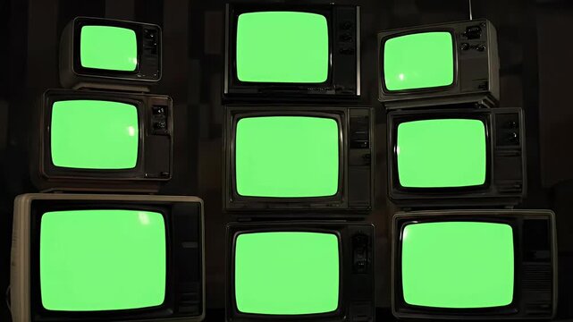A collection of vintage televisions displays static on the central screen, creating a nostalgic and slightly unsettling visual composition.