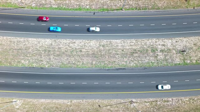 An Aerial shot of a freeway showing cars in both directions.