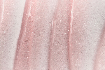 Fototapeta premium Shimmering pink cosmetic cream texture creating beautiful abstract background