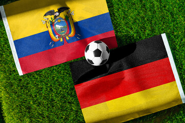 Fototapeta premium Ecuador vs Germany, national flags before world championship Group E group stage match, football on green pitch with goal in the background, East Rutherford, USA, June 25, 2026