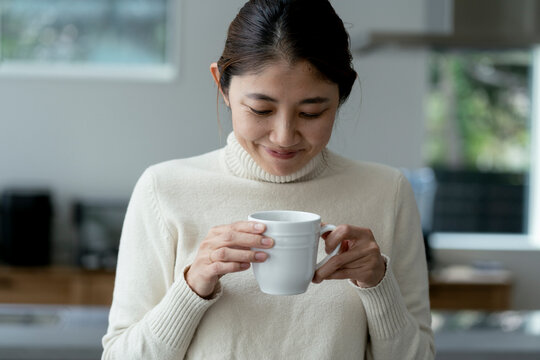 コーヒーカップを持つ40代日本人女性