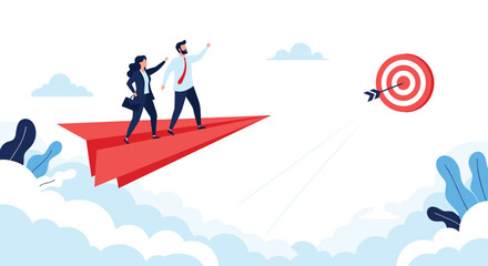 Obraz premium Businessman and businesswoman flying on a red paper airplane toward a target, representing teamwork and common goals.