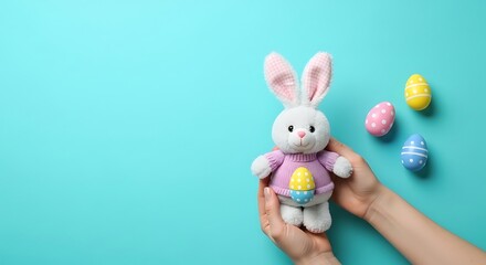 Obraz premium Two hands holding a cute plush Easter bunny toy