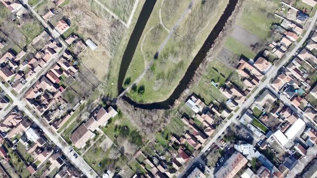 Aerial drone view of Kikinda park with lake and canals, residential neighborhood and fields, Serbia.Staro Jezero, Kikinda, Europe. g.