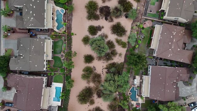 Aerial top down view of flooded residential area with flowing storm water